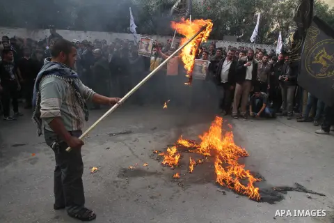 Palestinians burn a U.S flag and an Israeli flag during an anti-Israel rally organised by the Islamic Jihad movement over the entry restrictions to the al-Aqsa mosque, in Gaza City October 31, 2014. Muslim men over 50 pr...