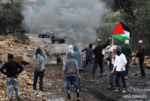 Palestinian protesters throw stones towards Israeli security forces during clashes following a weekly demonstration against the expropriation of Palestinian land by Israel in the village of Kafr Qaddum, near Nablus, in t...