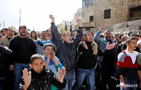 Palestinian protesters shout slogans during a demonstration following Friday prayers outside the Old City in east Jerusalem on October 31, 2014, following restrictions by Israeli police to allow entry only to Muslim men...
