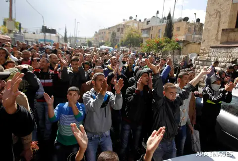 Palestinian protesters shout slogans during a demonstration following Friday prayers outside the Old City in east Jerusalem on October 31, 2014, following restrictions by Israeli police to allow entry only to Muslim men...