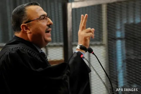 Egyptian lawyers attend the trial of Egyptian members of Muslim Brotherhood at the court in Cairo on Nov. 01, 2014. Morsi is being tried at a courtroom in the Police Academy in New Cairo along with 14 others on charges o...
