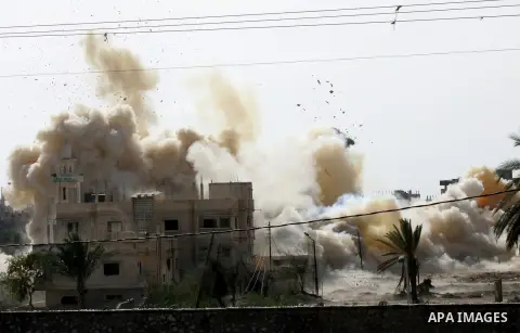 Smoke rises after a house was blown up during a military operation by Egyptian security forces in the Egyptian city of Rafah near the border with southern Gaza Strip Nov. 01, 2014, as Egypt began setting up a buffer zone...