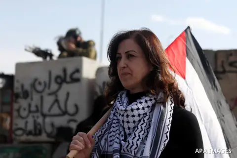 A Palestinian woman holds her national flag during a rally at the Qalandia checkpoint between Ramallah and Jerusalem City against the restrictions on the Al-Aqsa mosque compound on Nov. 02, 2014. Israeli Prime Minister B...