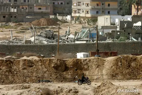 A Palestinian man rides a motorcycle along the border during a military operation by Egyptian security forces in the Egyptian city of Rafah near the border with southern Gaza Strip on November 2, 2014, as Egypt began set...