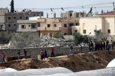Palestinians in Gaza look at a house destroyed by Egyptian security forces as they conducted an operation in the Egyptian city of Rafah near the border with southern Gaza Strip on November 2, 2014, as Egypt began setting...