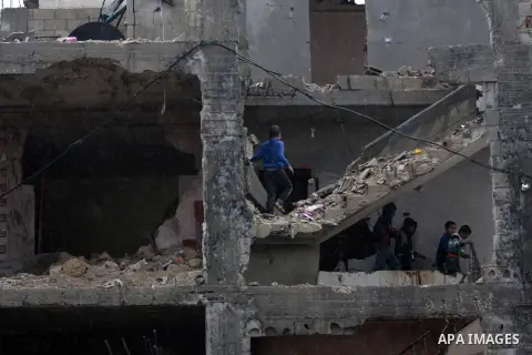 Palestinians play at their house that witnesses said was damaged by Israeli shelling during the most recent conflict between Israel and Hamas, on a rainy day in the east of Gaza City November 3, 2014. Photo by Yasser Qud...