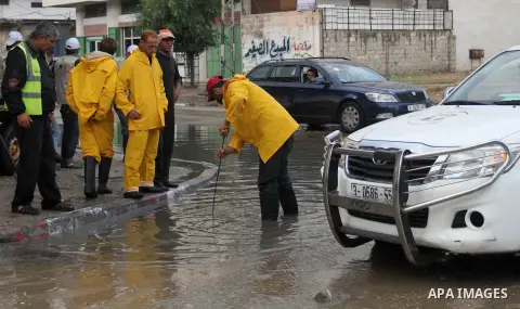 Palestinian civil defence try to remove a water in a street, on a rainy day in the east of Gaza City November 3, 2014. . Photo by Yasser Qudih