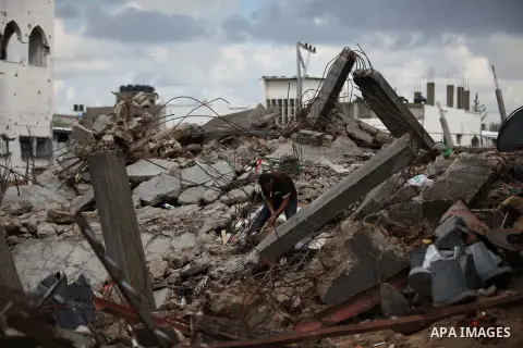 A Palestinian man inspects the ruins of a house that witnesses said was destroyed by Israeli shelling during the most recent conflict between Israel and Hamas, on a rainy day in the east of Gaza City November 3, 2014. Ph...