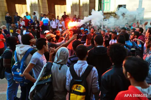 Egyptian students who support Muslim Brotherhood and ousted president Mohammed Morsi, shot slogans during a demonstration against military rule, at Cairo University in Cairo, Egypt, on November 3, 2014. Photo by Amr Saye...