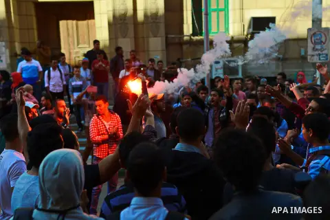Egyptian students who support Muslim Brotherhood and ousted president Mohammed Morsi, shot slogans during a demonstration against military rule, at Cairo University in Cairo, Egypt, on November 3, 2014. Photo by Amr Saye...