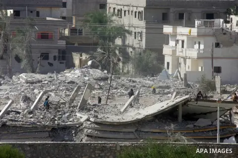 Egyptians inspect the debris of a house after it was blown up uring a military operation by Egyptian security forces in the Egyptian city of Rafah, near the border with southern Gaza Strip November 3, 2014. Egypt began c...