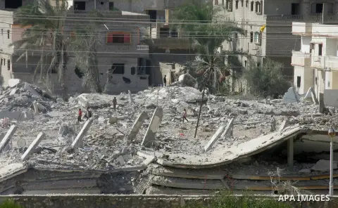 Egyptians inspect the debris of a house after it was blown up uring a military operation by Egyptian security forces in the Egyptian city of Rafah, near the border with southern Gaza Strip November 3, 2014. Egypt began c...