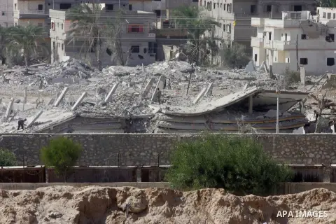 Egyptians inspect the debris of a house after it was blown up uring a military operation by Egyptian security forces in the Egyptian city of Rafah, near the border with southern Gaza Strip November 3, 2014. Egypt began c...