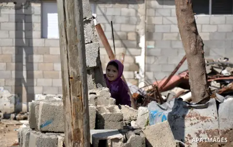 A Palestinian boy plays on the ruins of houses, which witnesses said were destroyed by Israeli shelling during the most recent conflict between Israel and Hamas following heavy rain at Shijaiyah neighborhood in the east...