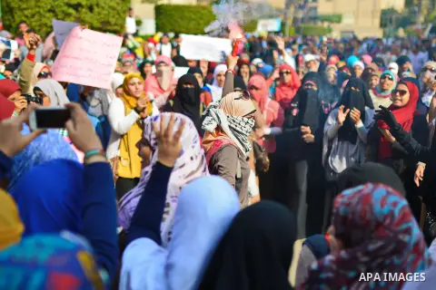 Egyptian students who support Muslim Brotherhood and ousted President Mohammed Morsi, hold placards during a demonstration demanding for release their fellow Radwa Jamal, who was arrested by Egyptian police, at Cairo Uni...