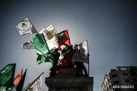 Members of the Palestinian factions hold national flags during a demonstration to show solidarity with Jerusalem and against the recent visits by Jewish activists to al-Aqsa mosque, in Gaza city November 9, 2014. In rece...