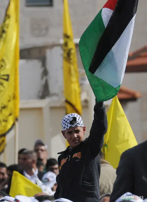 Palestinian President Mahmoud Abbas attends a ceremony marking the 10th anniversary of Yasser Arafat's death, in the West Bank city of Ramallah, on Nov. 11, 2014. Photo by Thaer Ganaim