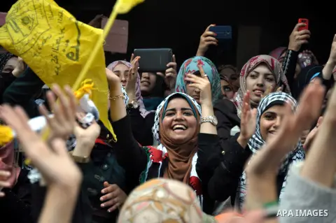 Supporters of the Palestinian Fatah movement shout slogans during a rally marking the tenth anniversary of late Palestinian leader and founder of the movement Yasser Arafat in front of the Al-Azhar University in Gaza Cit...