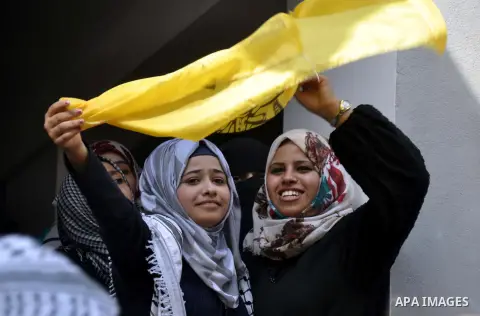 Supporters of the Palestinian Fatah movement shout slogans during a rally marking the tenth anniversary of late Palestinian leader and founder of the movement Yasser Arafat in front of the Al-Azhar University in Gaza Cit...