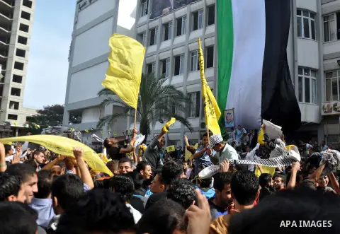 Supporters of the Palestinian Fatah movement shout slogans during a rally marking the tenth anniversary of late Palestinian leader and founder of the movement Yasser Arafat in front of the Al-Azhar University in Gaza Cit...