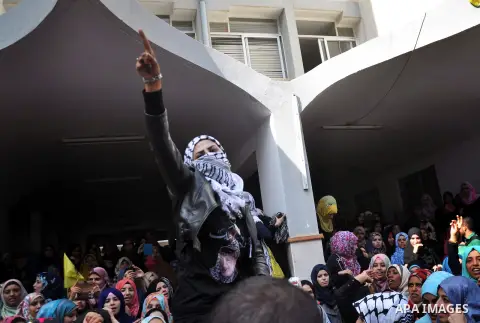 Supporters of the Palestinian Fatah movement shout slogans during a rally marking the tenth anniversary of late Palestinian leader and founder of the movement Yasser Arafat in front of the Al-Azhar University in Gaza Cit...