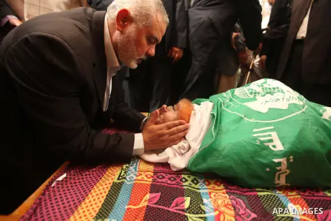 Senior leader of Hamas Ismail Haniyeh kisses the head of a co-founder of the Hamas movement Mohammad Salih Taha during his funeral in al-Bureij refugee camp in the central of Gaza strip, on Nov. 12, 2014. Taha, often cal...