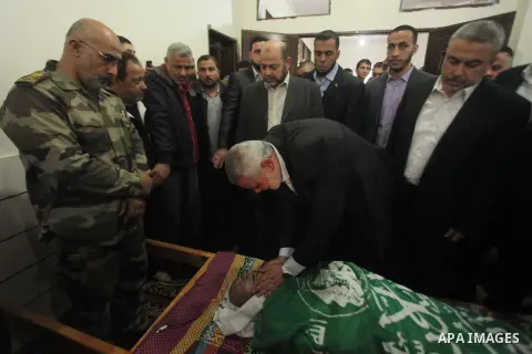 Senior leader of Hamas Ismail Haniyeh kisses the head of a co-founder of the Hamas movement Mohammad Salih Taha during his funeral in al-Bureij refugee camp in the central of Gaza strip, on Nov. 12, 2014. Taha, often cal...