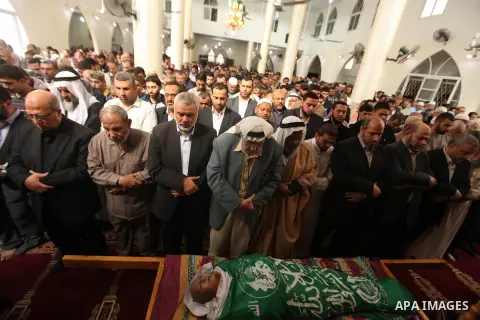 Senior leader of Hamas Ismail Haniyeh prays on the body of a co-founder of the Hamas movement Mohammad Salih Taha during his funeral in al-Bureij refugee camp in the central of Gaza strip, on Nov. 12, 2014. Taha, often c...