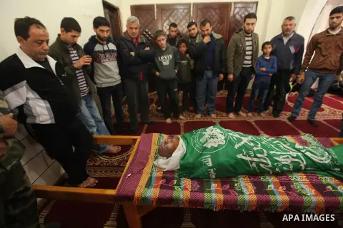 Palestinians mourn around the body of a co-founder of the Hamas movement Mohammad Salih Taha during his funeral in al-Bureij refugee camp in the central of Gaza strip, on Nov. 12, 2014. Taha, often called Abu Ayman, was...