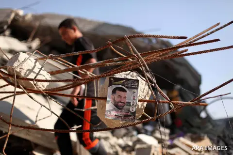 A Palestinian man walks on the rubble of of Hamas' military leader Ahmed Al-Jaabari home ((portrait in the front) at Shijaiya neighbourhood, in Gaza city on November 13, 2014. On November 14th 2012, Israel has decided to...