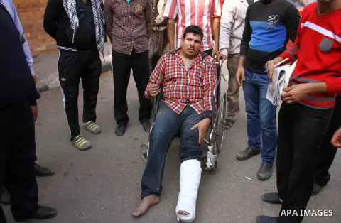Relatives and friends stand arround an injured Egyptian man following an explosion at the Hilmiyat al-Zaytoun metro station, in Cairo November 13, 2014. A sonic device has caused at least 16 injuries after detonating at...