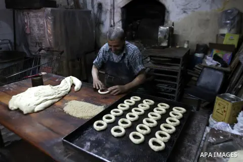 Palestinian baker Darwish Abu Samra, 77, bakes a traditional cake called 'Shami' at his old bakery in the old city of Nablus, West Bank, 02 November 2014. Abu Samra said his family started in this bakery in 1936 and sinc...