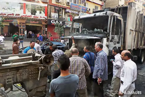 Egyptians inspect a garbage truck after it was burned during a demonstration organised by supporters of ousted president Mohammed morsi and Muslim Brotherhood against the military rule, in Cairo on November 14, 2014. Pho...