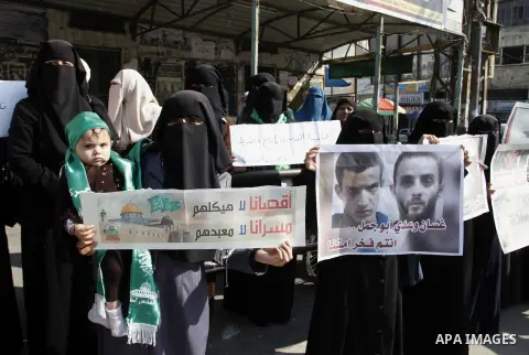 Palestinians celebrate with others an attack on a Jerusalem synagogue, in Rafah in the southern Gaza Strip November 18, 2014. Two Palestinians armed with a meat cleaver and a gun killed four people in a Jerusalem synagog...