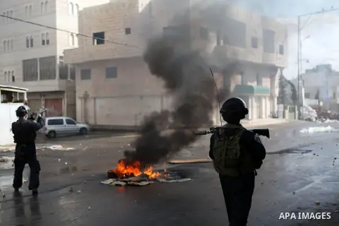 Israeli security forces take position during clashes with Palestinian protesters following a protest against the recent Israeli measures in Jerusalem, in the West Bank city of Hebron, November 21, 2014. Israel eased age...