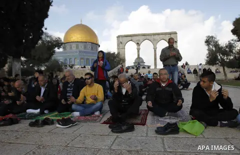 Palestinian worshippers take part in Friday prayers outside the Dome of the Rock at the Al-Aqsa mosque compound in the Old City of Jerusalem on November 21, 2014. Israel eased age restrictions for Friday prayers at Jerus...
