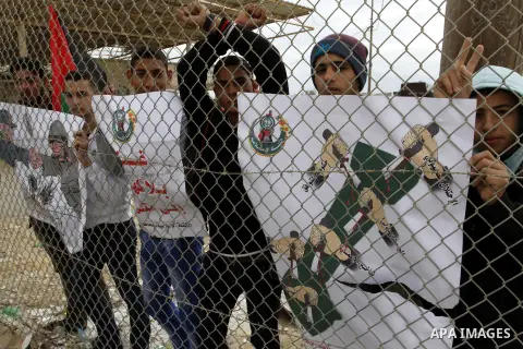 Palestinians take part in a demonstration calling on the Egyptian authorities to open the Rafah border crossing, at the crossing in the southern Gaza Strip on November 23, 2014. The crossing, Gaza's only gateway to the w...