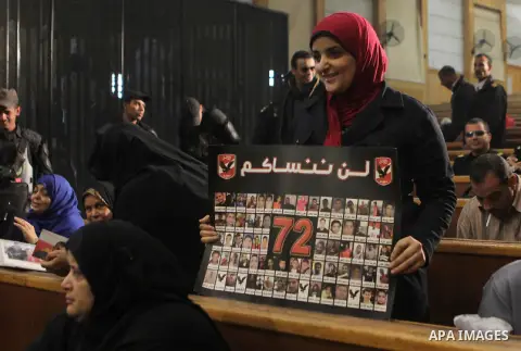 Egyptian relatives of victim in the case of last year's soccer violence in Port Said, attends their trial at a court, in Cairo, Egypt, on Nov. 24. 2014. The case of last year's soccer violence in Port Said which left ove...
