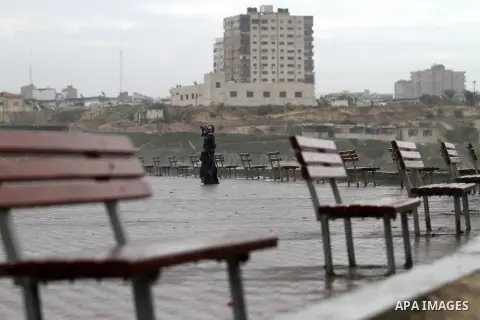 A Palestinian girl stands on the beach during a rainy day, in Gaza city November 24, 2014. Photo by Yasser Qudih