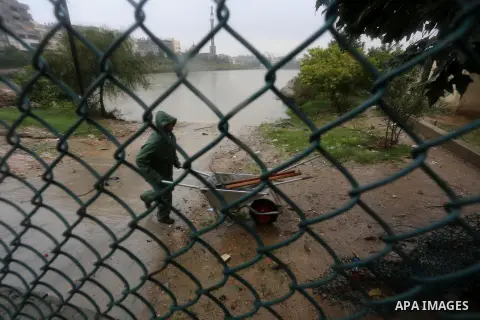 A Palestinian man prevents rain water from flooding a houses following heavy rain in Gaza City November 27, 2014. The civil defence asked residents in an area east of Gaza City to evacuate their homes to avoid being trap...