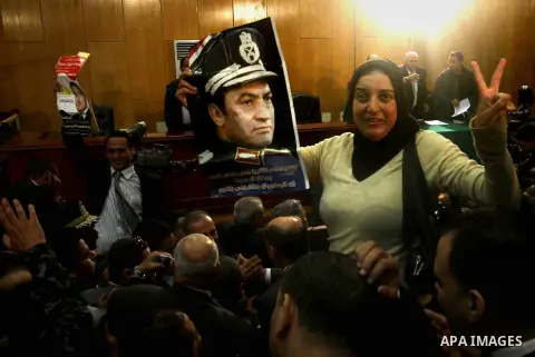 Egyptians celebrate after a Cairo criminal court cleared Egypt's former president Hosni Mubarak over killing protesters during the 2011 protests in Cairo, Egypt, Nov. 29, 2014 after a court dismissed a murder charge agai...