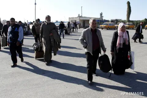 Palestinians cross into Gaza through the Rafah border crossing between Egypt and southern Gaza Strip on November 30, 2014. Egyptian authorities reopened this week the Rafah crossing with Gaza for two days this week to al...