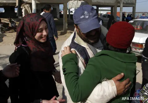 Palestinians cross into Gaza through the Rafah border crossing between Egypt and southern Gaza Strip on November 30, 2014. Egyptian authorities reopened this week the Rafah crossing with Gaza for two days this week to al...
