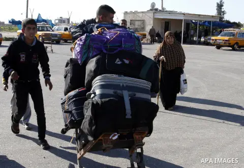 Palestinians cross into Gaza through the Rafah border crossing between Egypt and southern Gaza Strip on November 30, 2014. Egyptian authorities reopened this week the Rafah crossing with Gaza for two days this week to al...