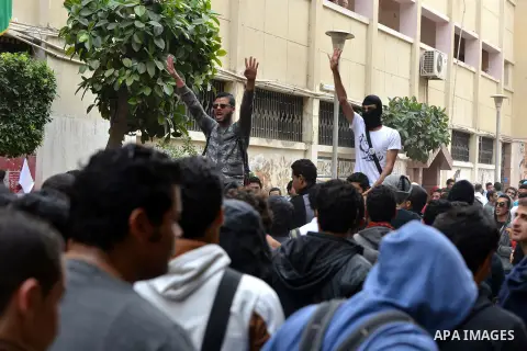 Egyptian students who are members in Students Against the Coup group (SAC), take part in a demonstration against the Cairo Criminal Court's decision to drop charges against former president Hosni Mubarak, at Cairo Univer...