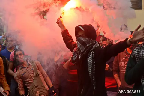 Egyptian students who are members in Students Against the Coup group (SAC), take part in a demonstration against the Cairo Criminal Court's decision to drop charges against former president Hosni Mubarak, at Cairo Univer...
