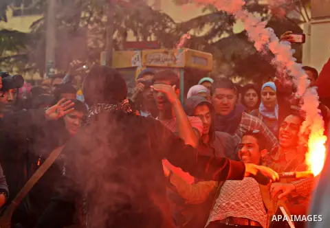 Egyptian students who are members in Students Against the Coup group (SAC), take part in a demonstration against the Cairo Criminal Court's decision to drop charges against former president Hosni Mubarak, at Cairo Univer...