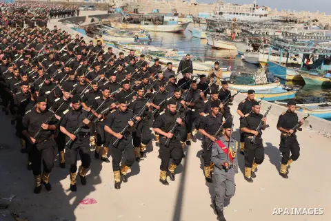 Members of Palestinian security forces march during a graduation ceremony in Gaza City December 4, 2014. Photo by Ashraf Amra