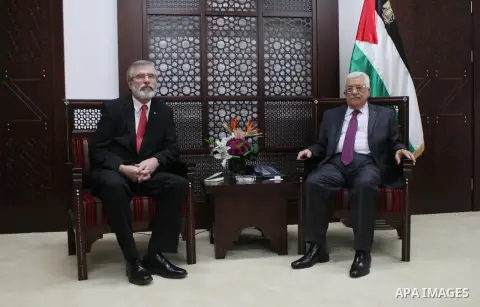Palestinian President, Mahmoud Abbas, attends a meeting with Sinn Fein leader Gerry Adams in the West Bank city of Ramallah on December 4, 2014. Photo by Shadi Hatem