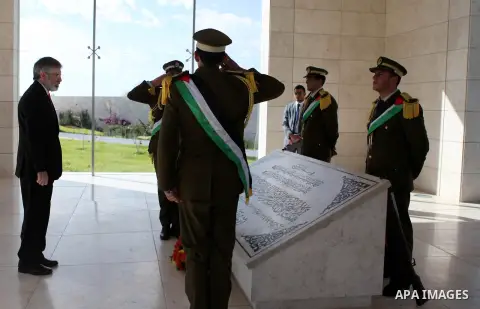 Sinn Fein leader Gerry Adams lays a wreath on the tomb of late Palestinian leader Yasser Arafat upon his arrival in the West Bank city of Ramallah on December 4, 2014. Photo by Shadi Hatem
